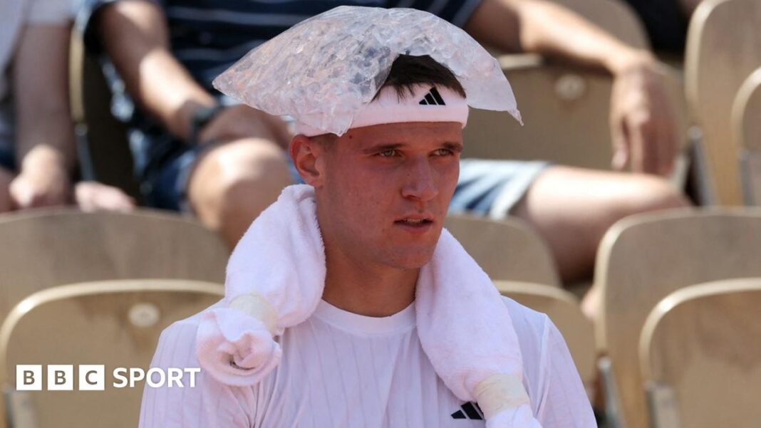 Jakub Mensik sits with an ice pack on his head during his first-round match at the French Open